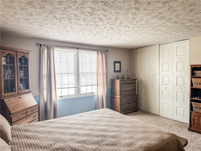 bedroom featuring carpet, a closet, and a textured ceiling