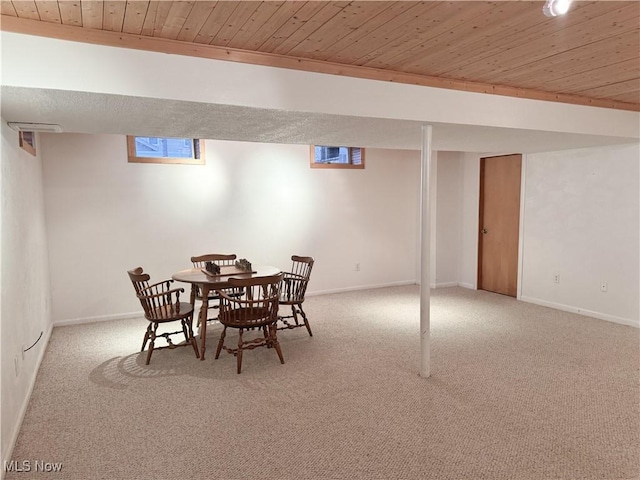 dining area featuring carpet, wood ceiling, and baseboards