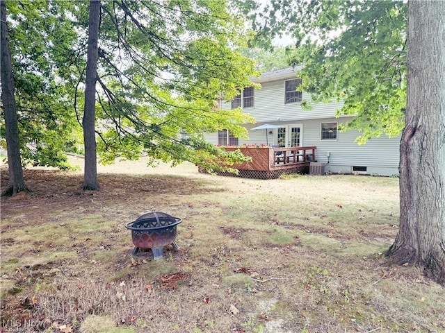 view of yard with a fire pit and a deck