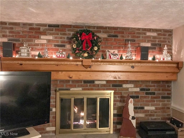 interior details with a brick fireplace and a textured ceiling