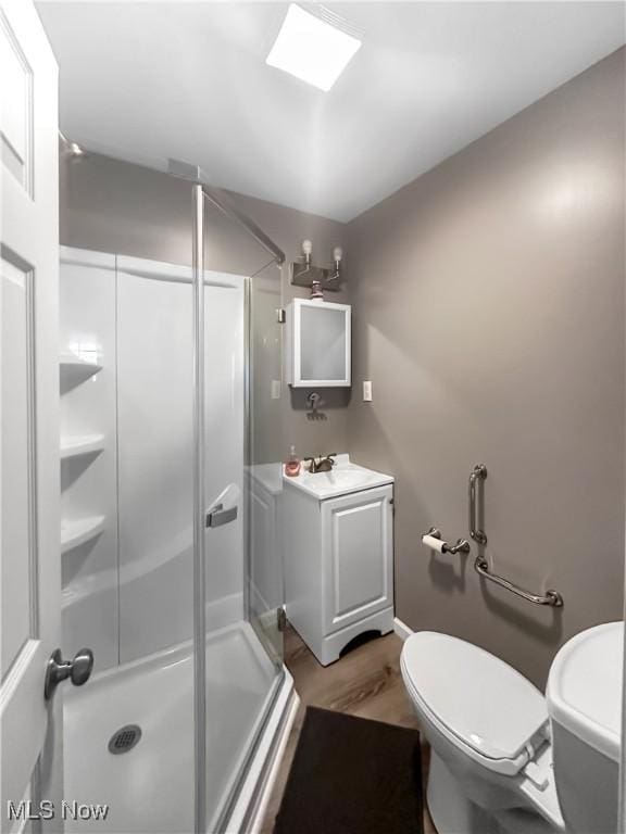 471 E N Ave, East Palestine, OH 44413 - bathroom with a shower stall, toilet, vanity, and wood finished floors