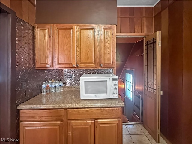 471 E N Ave, East Palestine, OH 44413 - kitchen featuring white microwave, light stone countertops, and light tile patterned floors