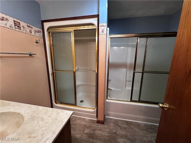 full bathroom featuring enclosed tub / shower combo and vanity