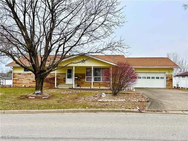 view of front of property with a garage, covered porch, and concrete driveway