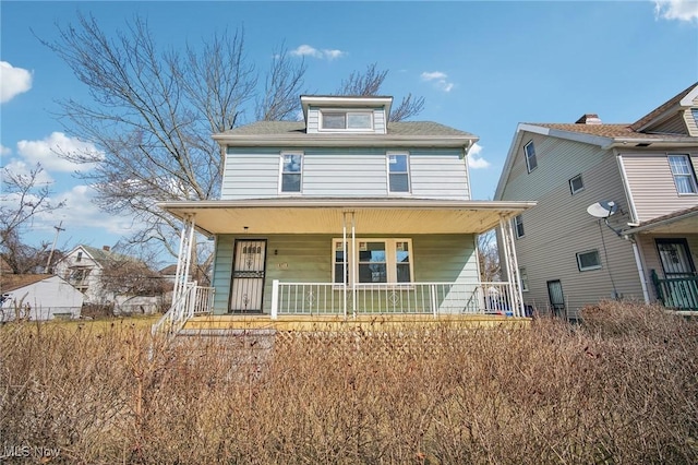 american foursquare style home with covered porch