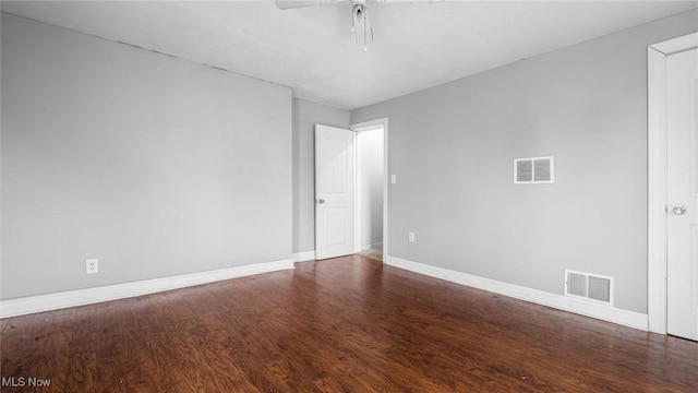 spare room with visible vents, ceiling fan, baseboards, and wood finished floors