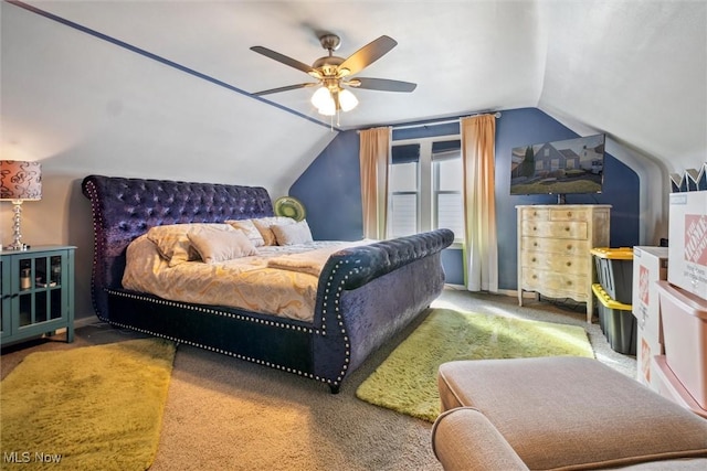 carpeted bedroom with vaulted ceiling and a ceiling fan