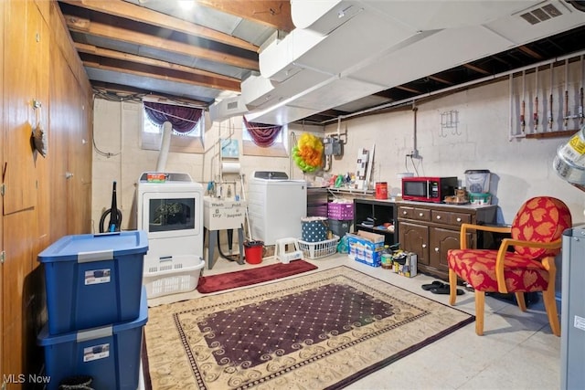 below grade area featuring visible vents, a sink, and separate washer and dryer