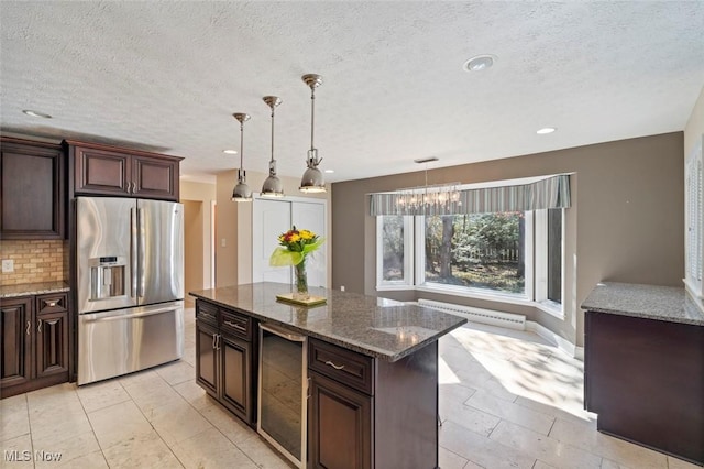 kitchen with wine cooler, backsplash, a baseboard heating unit, dark stone countertops, and stainless steel fridge