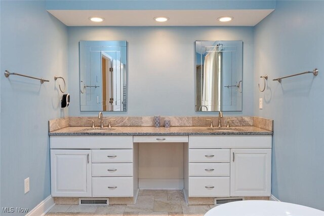 full bath featuring double vanity, a sink, and visible vents