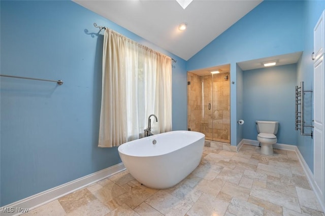 bathroom with a soaking tub, a shower stall, baseboards, and vaulted ceiling