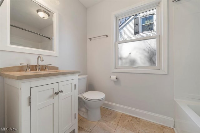 bathroom with toilet, vanity, baseboards, walk in shower, and a bathtub