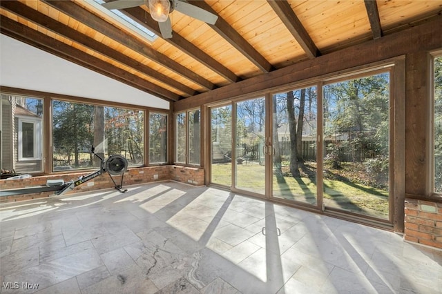 unfurnished sunroom featuring lofted ceiling with beams, ceiling fan, and wooden ceiling