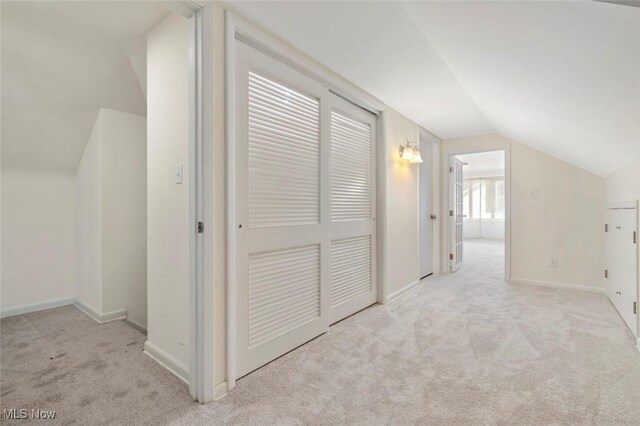 bonus room featuring vaulted ceiling, carpet floors, and baseboards