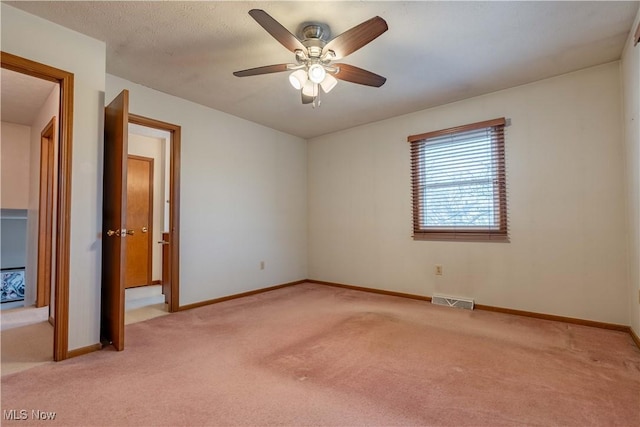 unfurnished room featuring baseboards, visible vents, and light colored carpet