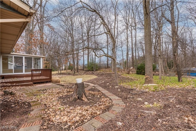 view of yard with a sunroom and a deck