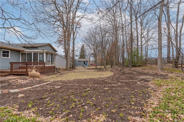 view of yard with fence and a deck