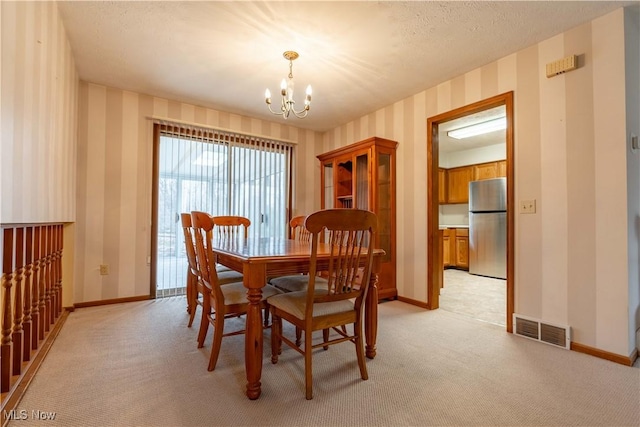 dining room with visible vents, light carpet, baseboards, and wallpapered walls