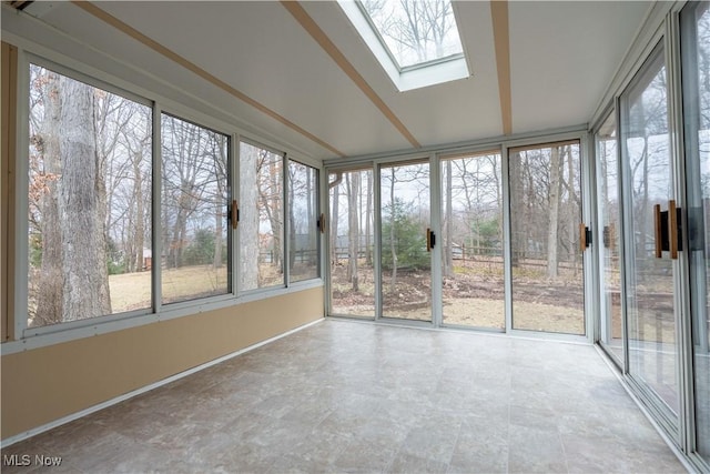 unfurnished sunroom with a skylight and a wealth of natural light