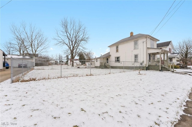 exterior space with a chimney and fence