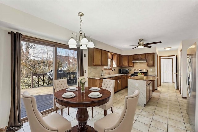 dining space featuring ceiling fan with notable chandelier and light tile patterned floors