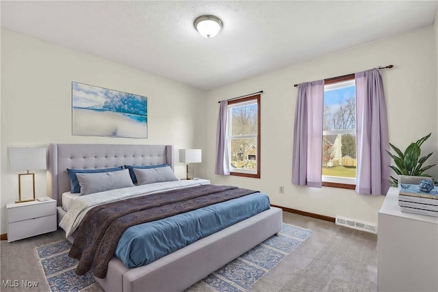 carpeted bedroom featuring baseboards and visible vents