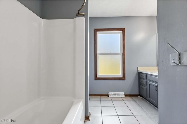 full bath featuring visible vents, tub / shower combination, vanity, tile patterned flooring, and baseboards