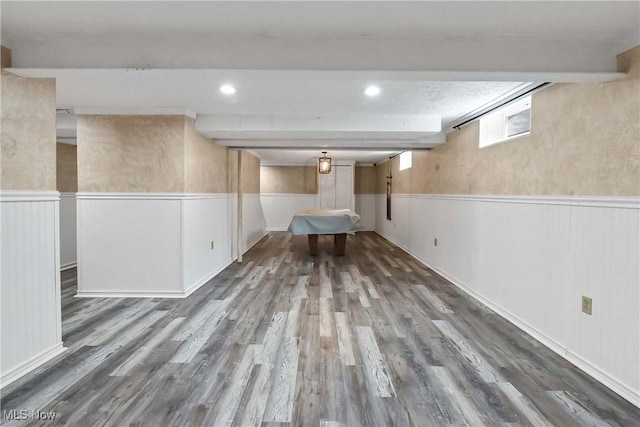 below grade area featuring recessed lighting, wood finished floors, and wainscoting