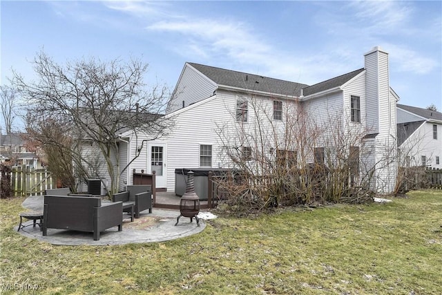 back of property featuring a patio, a yard, fence, and a hot tub