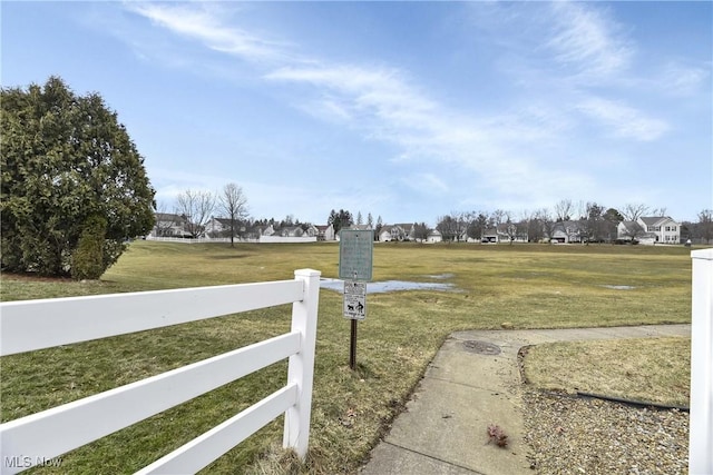 view of gate featuring a yard and fence