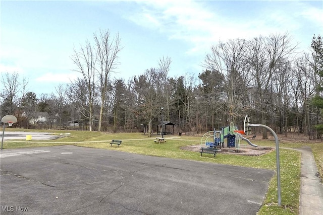 exterior space featuring community basketball court and a lawn