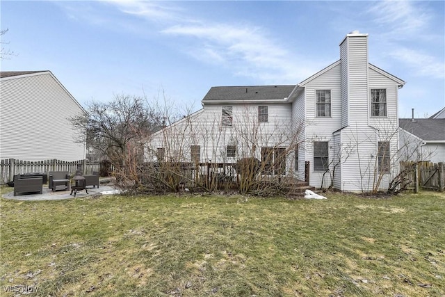 back of property featuring a yard, a chimney, a patio area, and fence