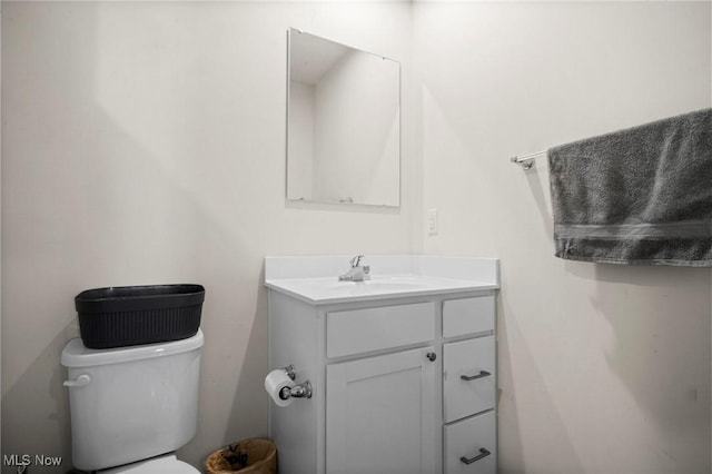 half bath featuring toilet and vanity