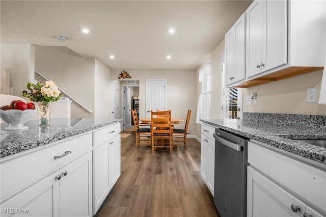 kitchen with dark wood-style floors, white cabinets, light stone counters, and stainless steel dishwasher