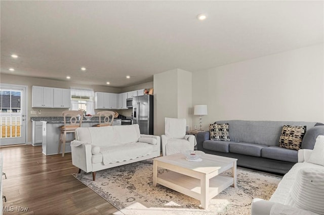 living area with wood finished floors and recessed lighting