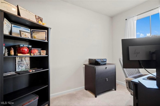 home office with light carpet and baseboards