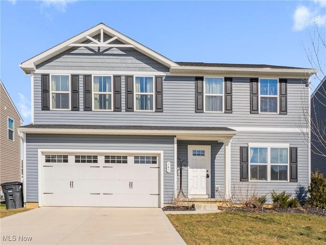 view of front of home featuring a front lawn, driveway, and an attached garage