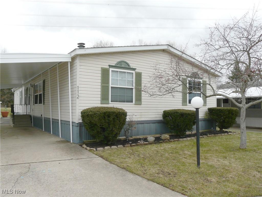 27202 Cook Rd Unit 112, Olmsted Township, OH 44138 - view of property exterior with entry steps, a yard, and driveway