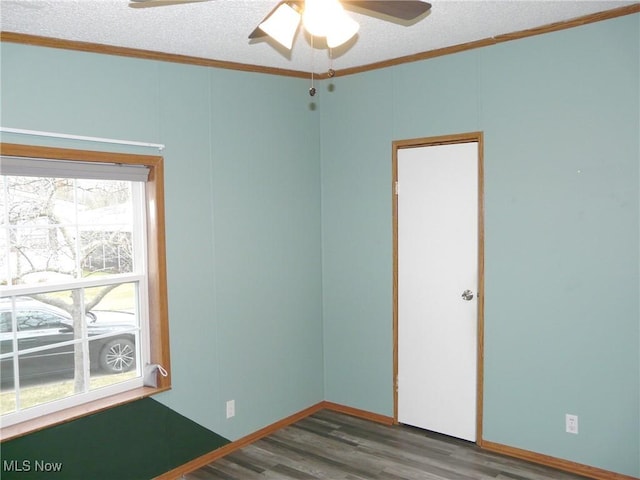 unfurnished room featuring a textured ceiling, ornamental molding, wood finished floors, and a ceiling fan