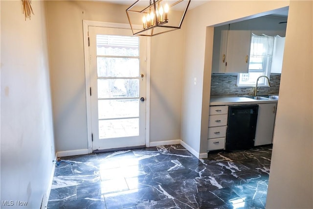 doorway to outside with marble finish floor, a sink, and baseboards