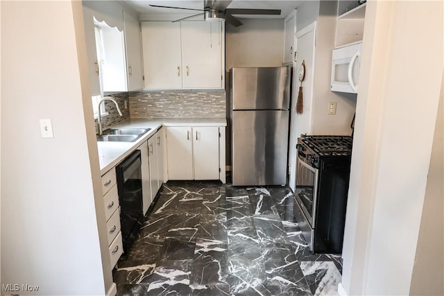 kitchen featuring appliances with stainless steel finishes, marble finish floor, light countertops, white cabinetry, and a sink