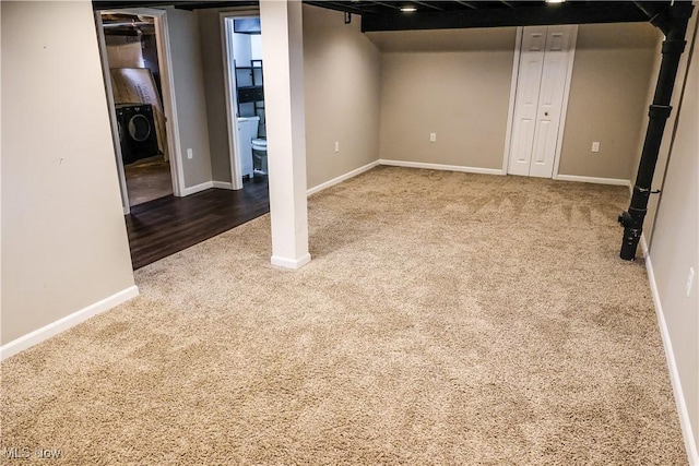 finished below grade area featuring washer / clothes dryer, carpet flooring, and baseboards