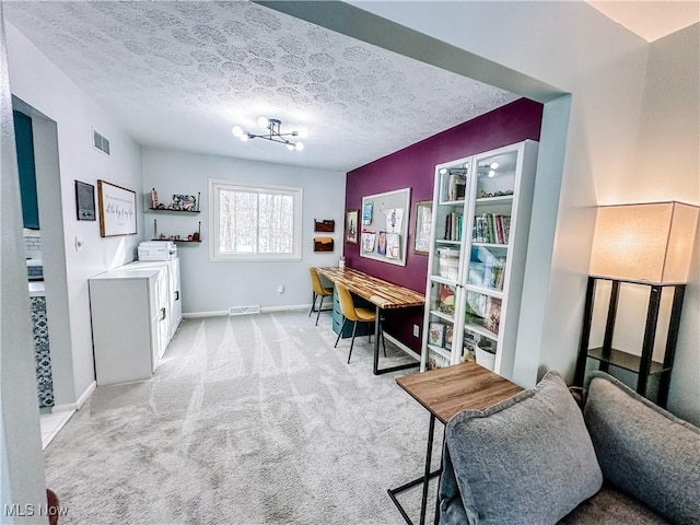 office space with baseboards, visible vents, a textured ceiling, and light colored carpet