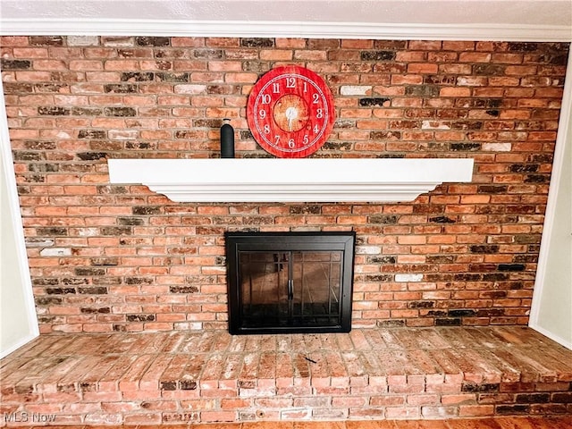 interior details with a fireplace and crown molding