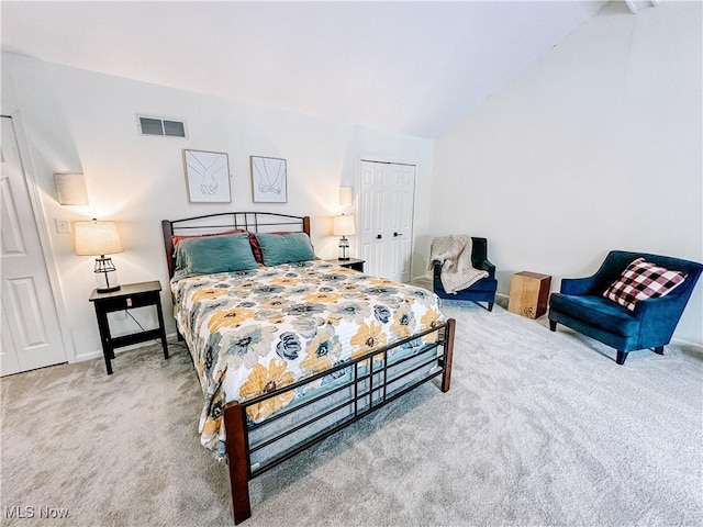 carpeted bedroom featuring lofted ceiling, a closet, visible vents, and baseboards