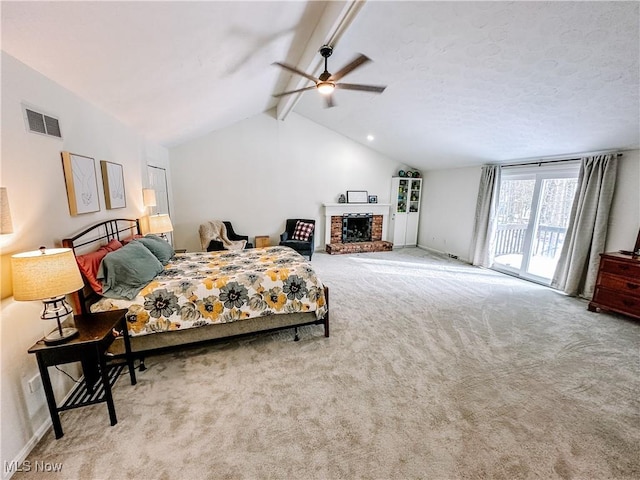 bedroom with carpet, visible vents, lofted ceiling with beams, a brick fireplace, and access to outside