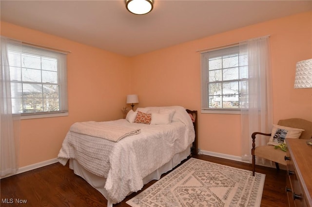 bedroom featuring dark wood-style floors and baseboards