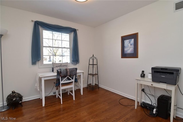 office featuring baseboards, visible vents, and wood finished floors