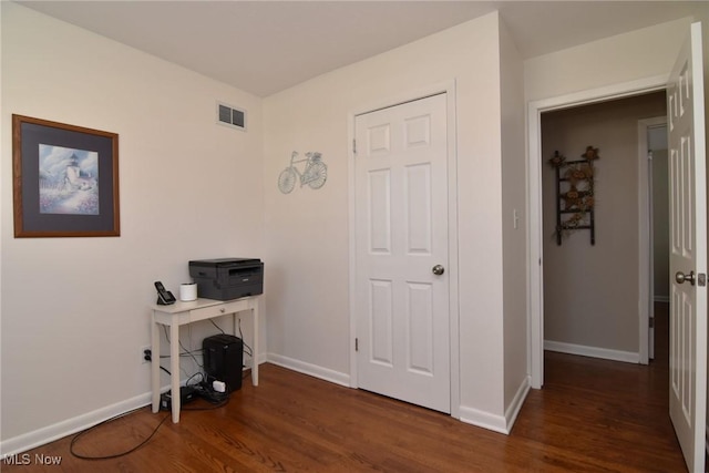 home office with visible vents, baseboards, and wood finished floors