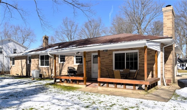 view of front of property with a porch and a chimney